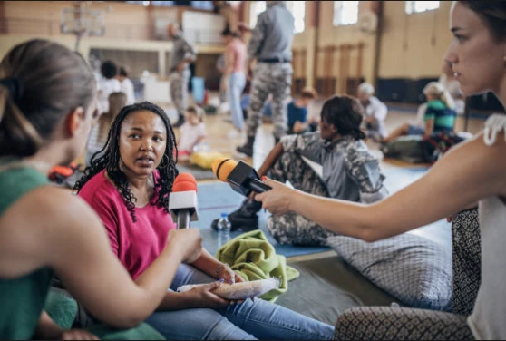 People sharing supplies at a community table.