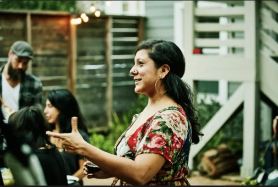 A woman speaking with other community members.